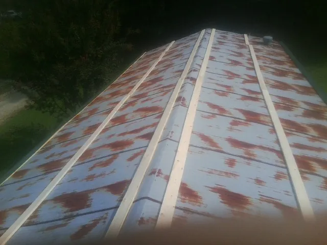 Rusted metal roof panels with new wood purlins before replacement — Storm Damage Roof Repair in Goehner by Roofing Brothers